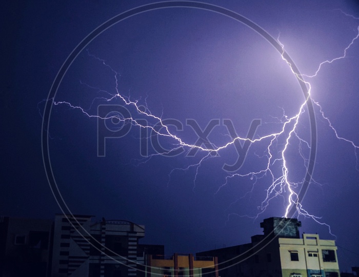 Thunder  Light Or Spark Over Urban Buildings Background
