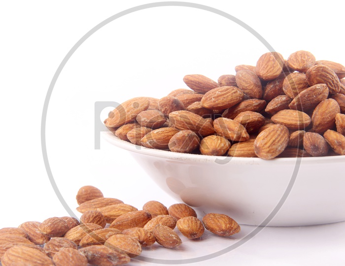 Roasted Almonds Or Badam Nuts In a Bowl On an Isolated White Background