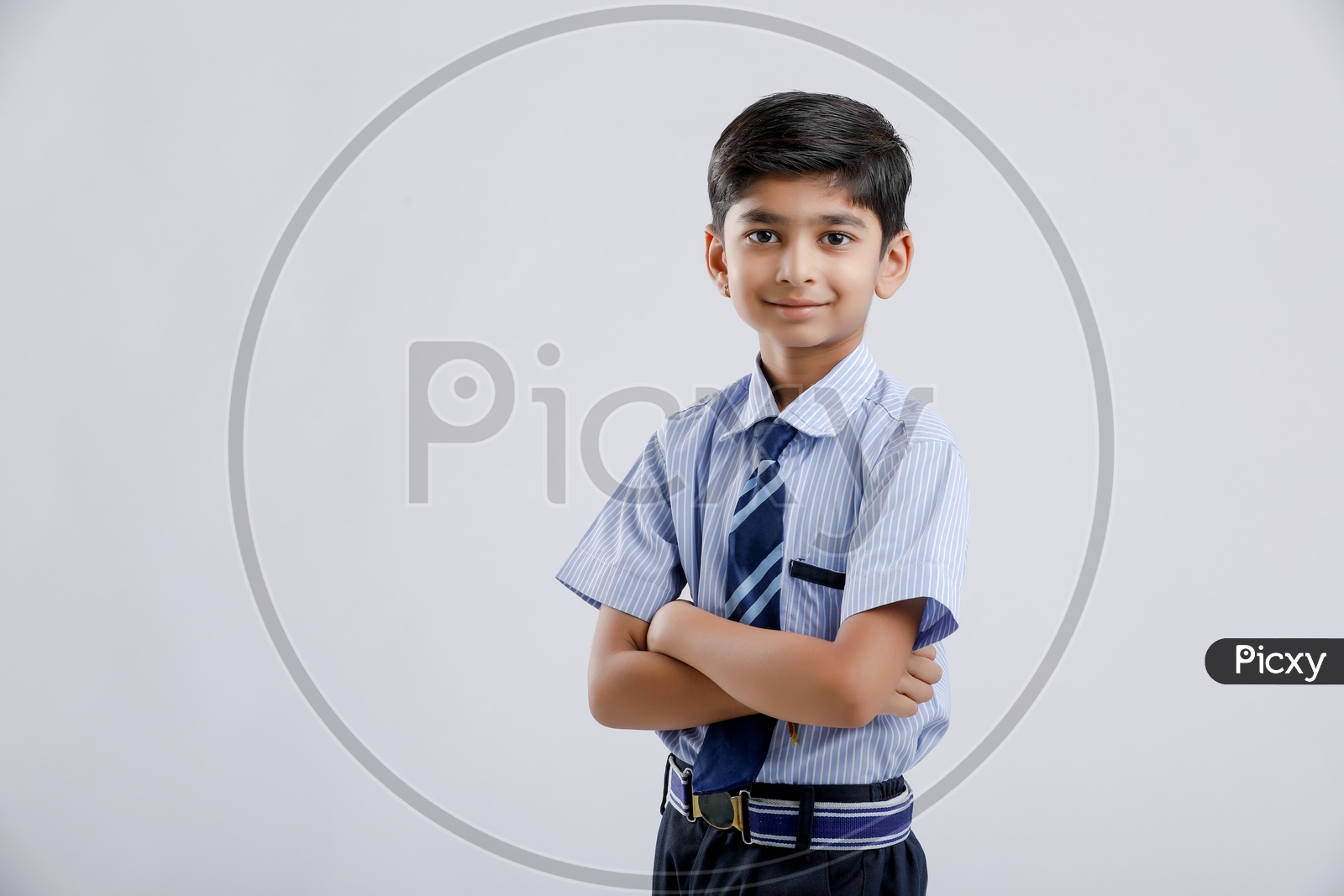 Cute Indian or Asian Kid Or Boy In School Uniform And Posing Over an Isolated White Background