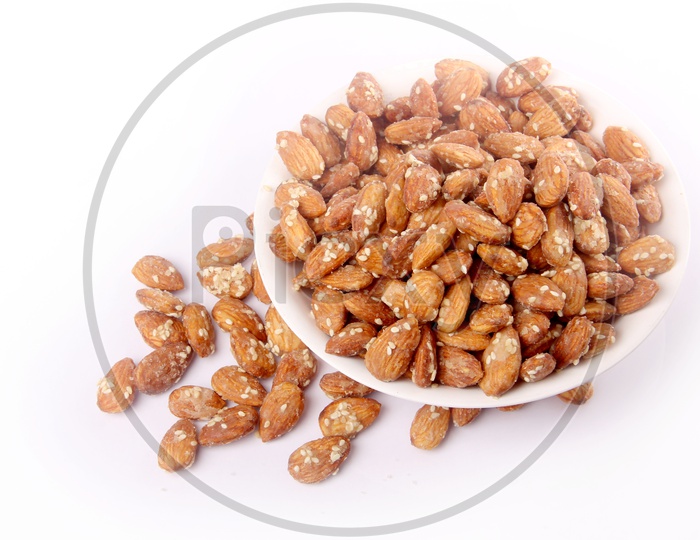 Sugar Coated Almonds Or Badam Nuts In A Bowl On an Isolated White Background