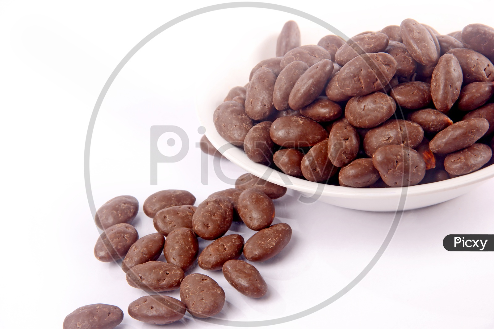 Chocolate Coated Almond Or Badam  in a Bowl On an Isolated White Background
