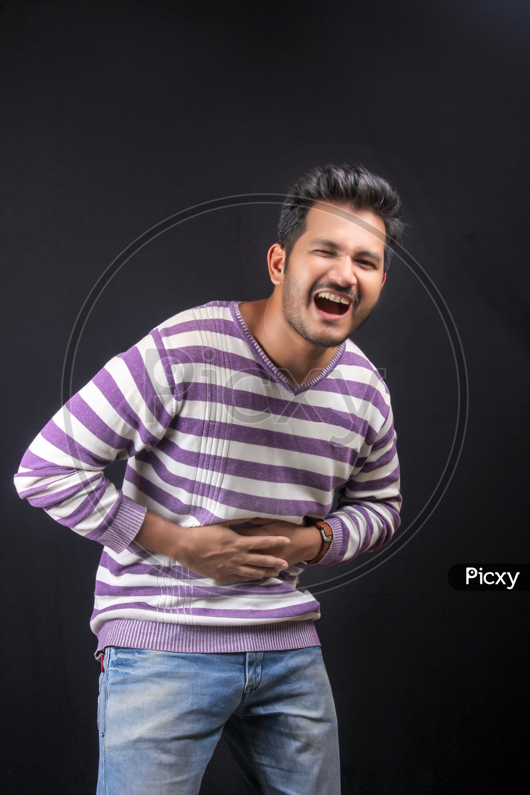Young Indian Man  Health Illness Catching Stomach  On an Isolated Black Background