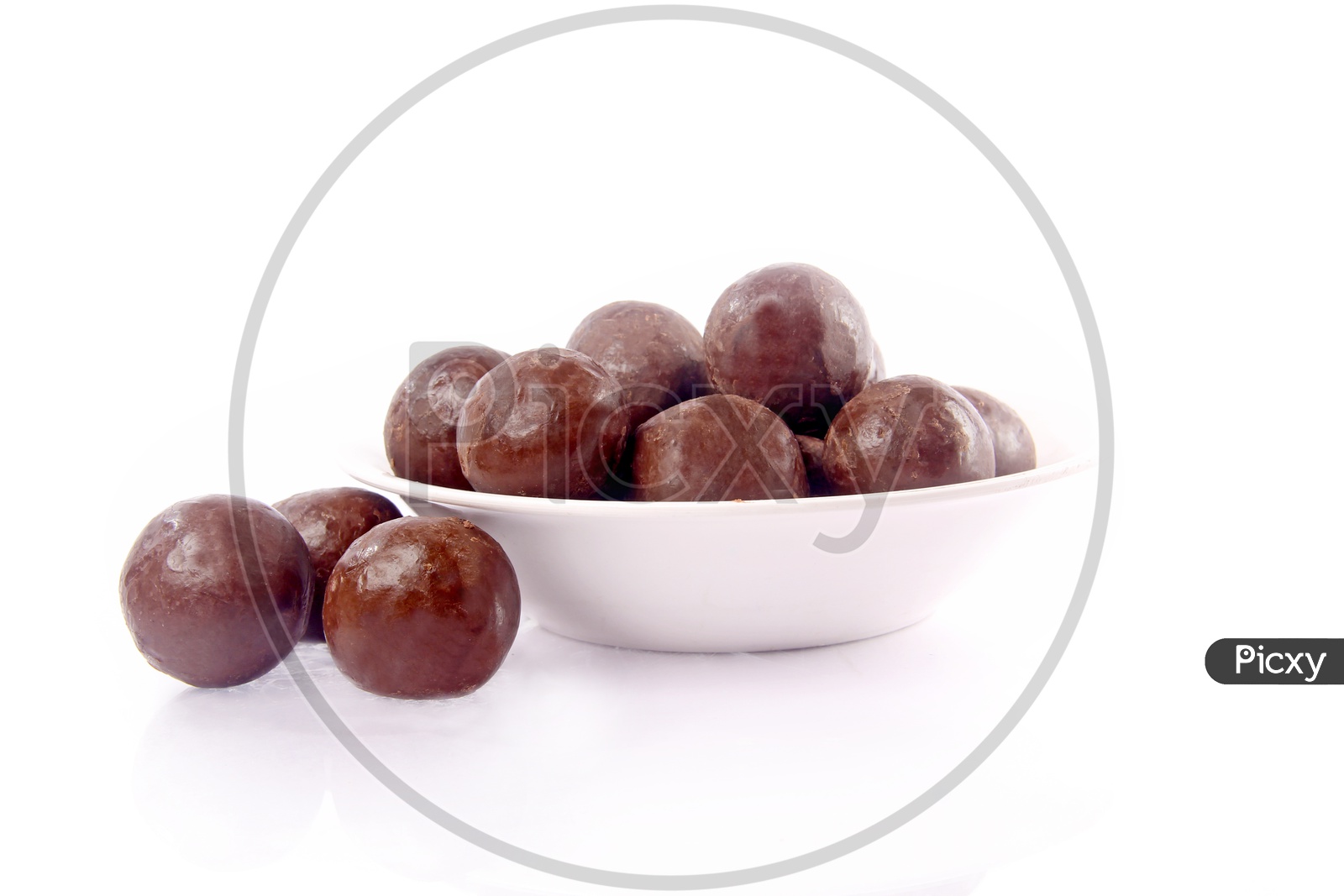Chocolate Coated Hazel Nuts in a Bowl On an Isolated White Background