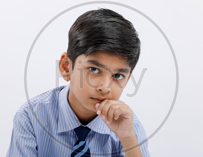 Indian School Boy Or Kid Wearing Uniform And Posing Over White Isolated Background