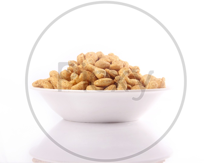 Spicy Roasted Cashew Nuts In a Bowl On an Isolated White Background