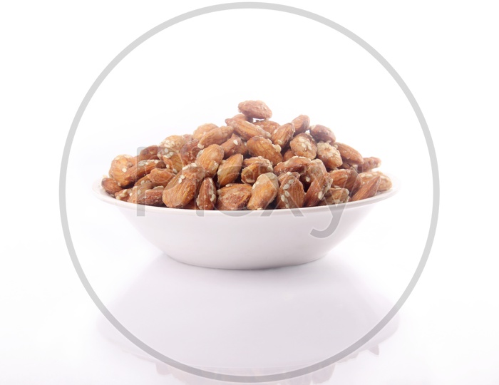 Sugar Coated Almonds Or Badam Nuts In A Bowl On an Isolated White Background