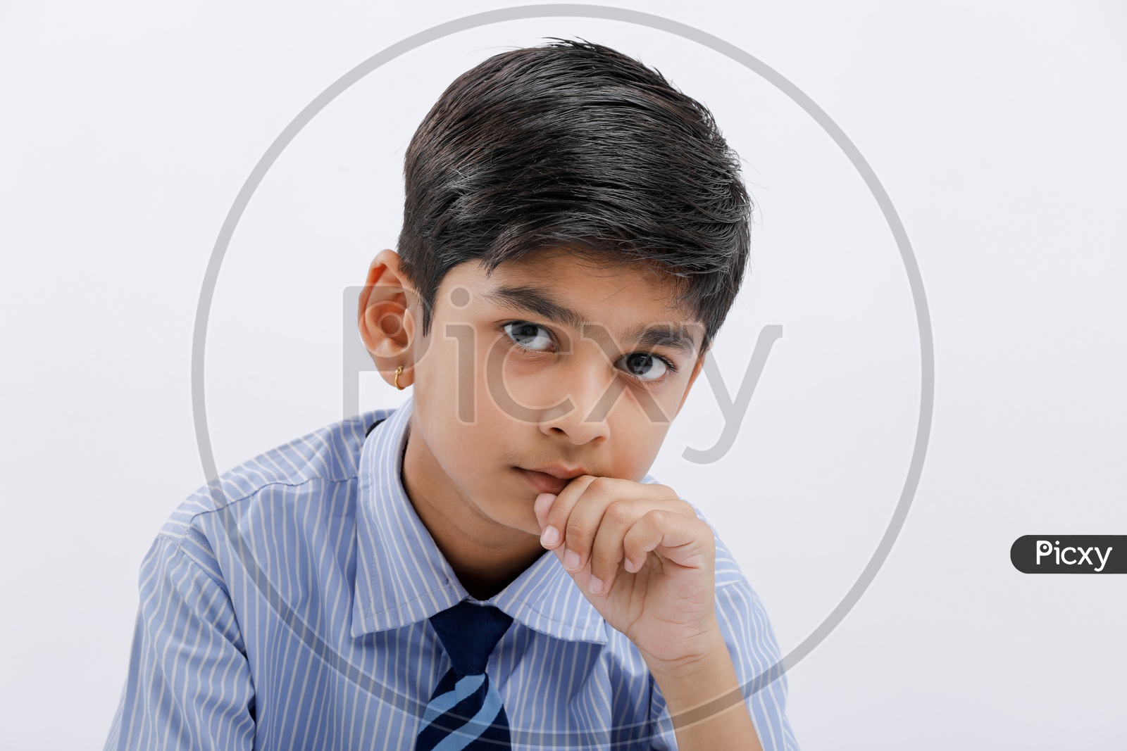 Indian School Boy Or Kid Wearing Uniform And Posing Over White Isolated Background