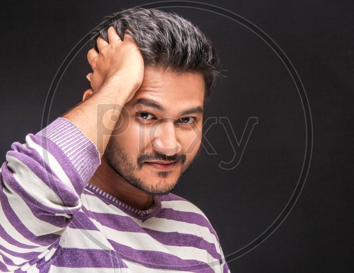 Young Indian Man Posing With Multiple Expressions On an Isolated Black Background