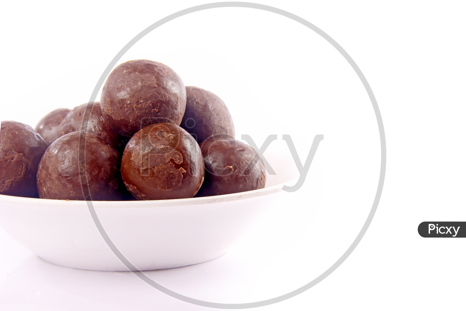 Chocolate Coated Hazel Nuts in a Bowl On an Isolated White Background