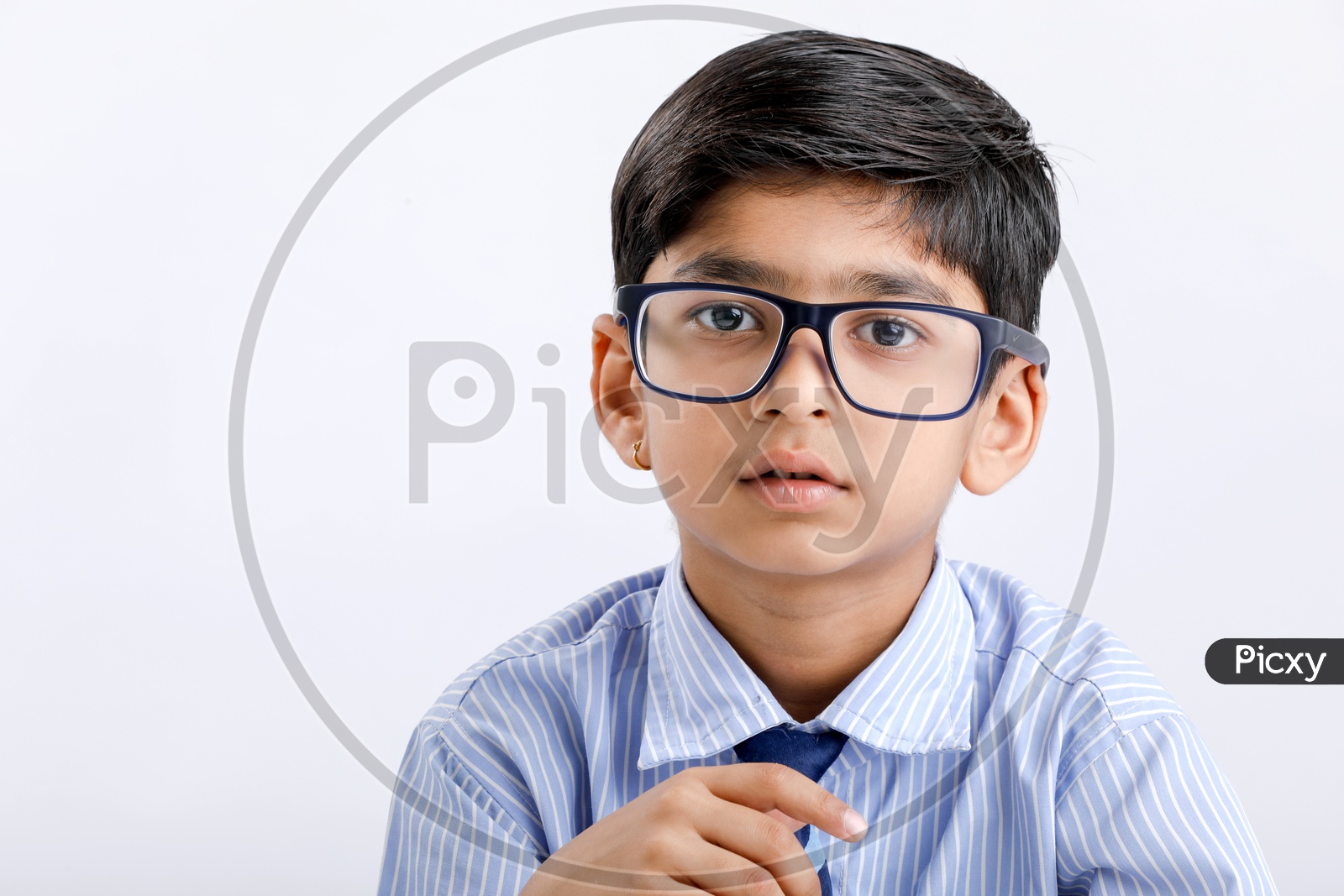 Indian or Asian School Kid Or Boy Wearing Uniform  And Posing With Spectacles  Over an Isolated White Background