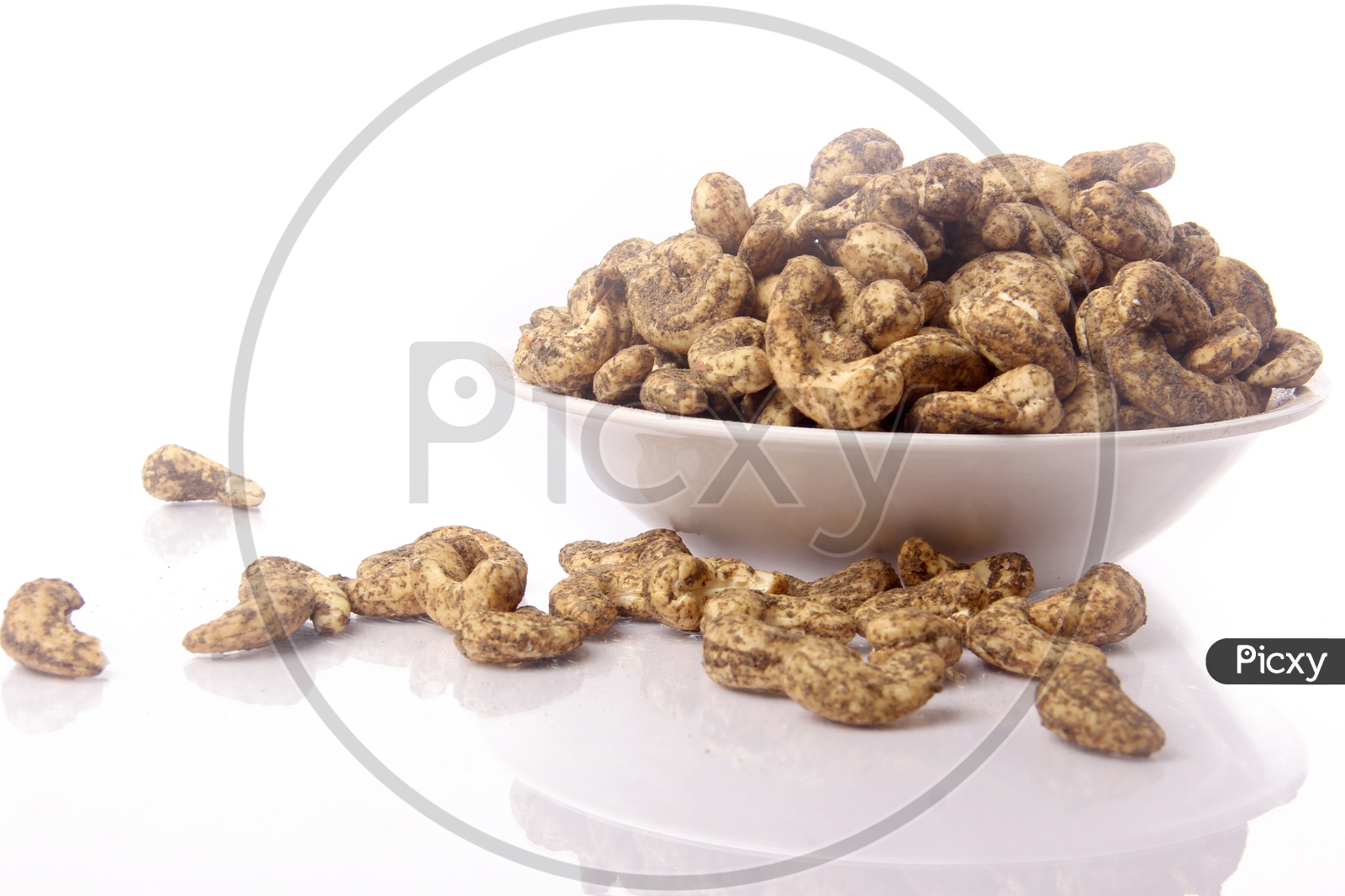 Spicy Roasted Cashew Nuts In A Bwl On an Isolated Background