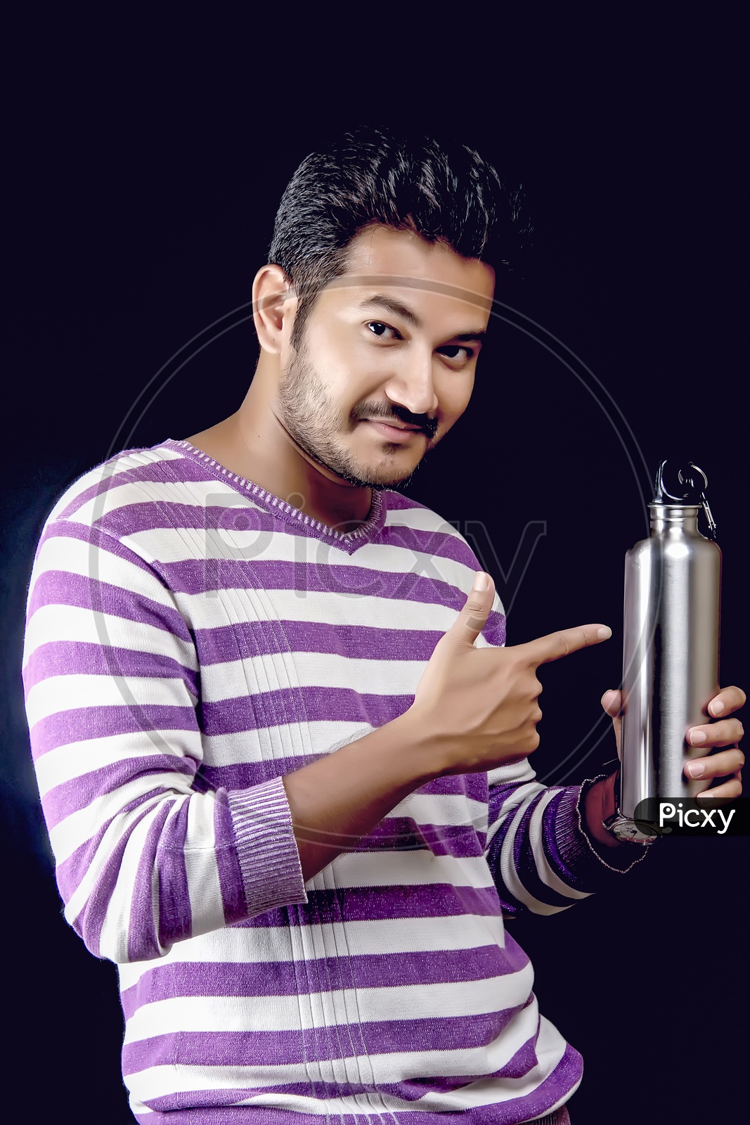 Young Indian Man Posing With Water Bottle  On an Isolated Black Background