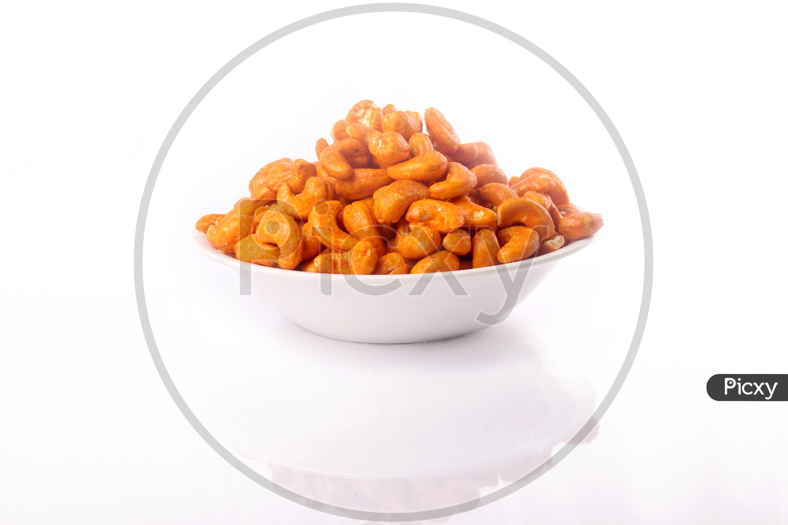 Spicy Roasted Cashew Nuts In a Bowl On an Isolated White Background