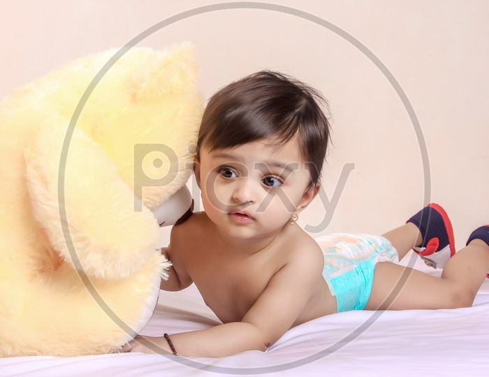 Cute Indian Baby Child Playing With Toys Or Dolls
