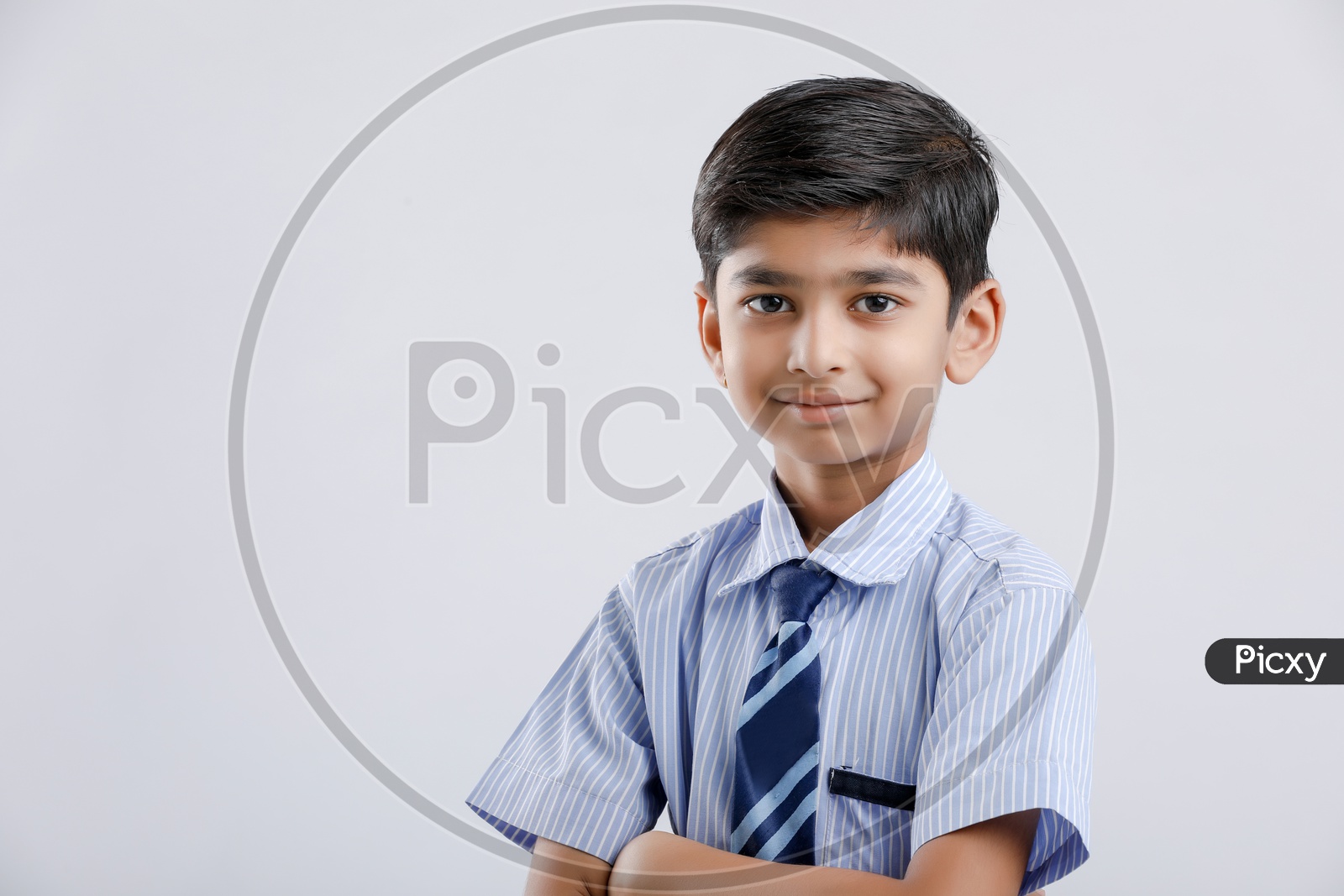 Cute Indian or Asian Kid Or Boy In School Uniform And Posing Over an Isolated White Background