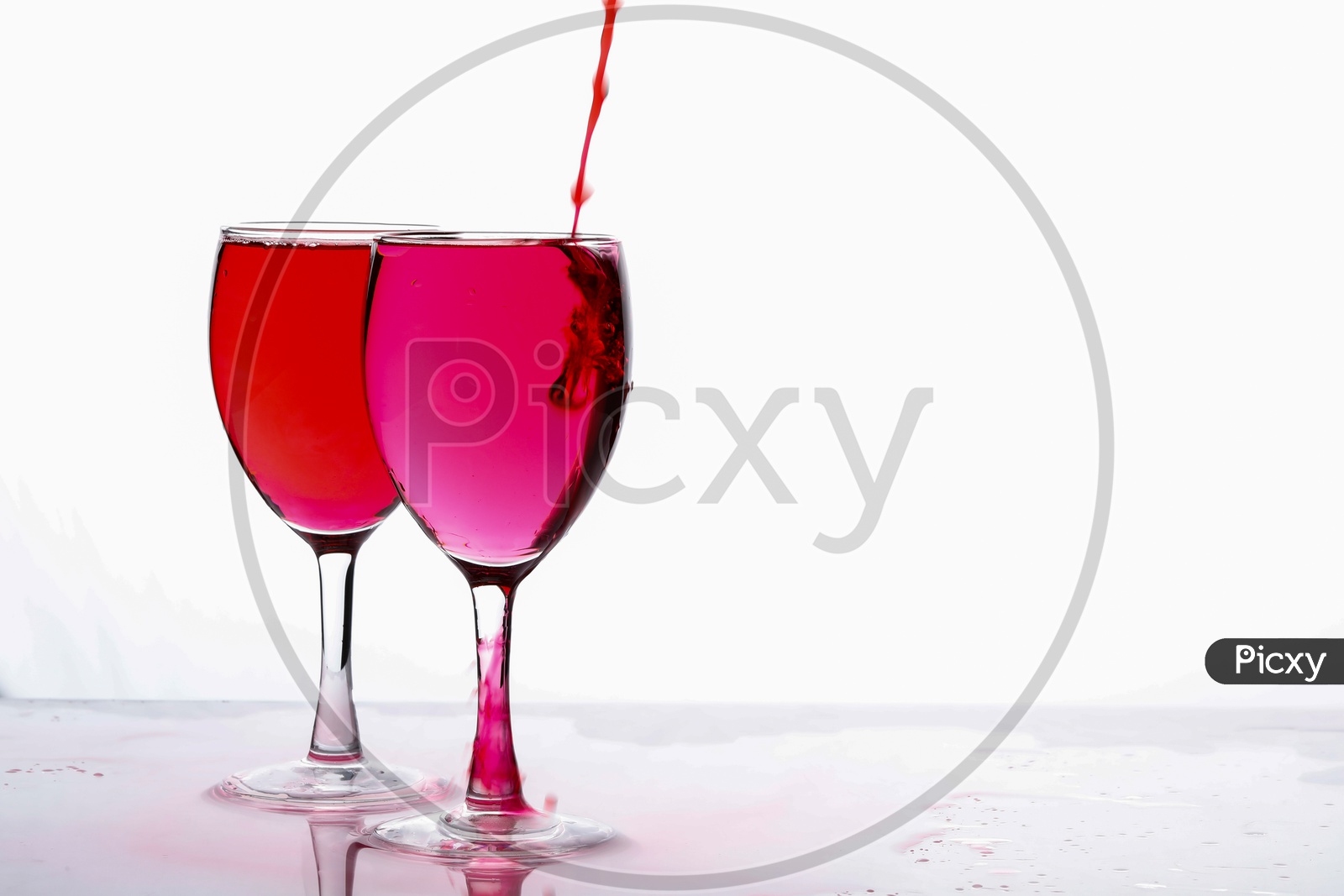 Red Food Colouring Diffuse In water in a Wine Glass On an Isolated White Background