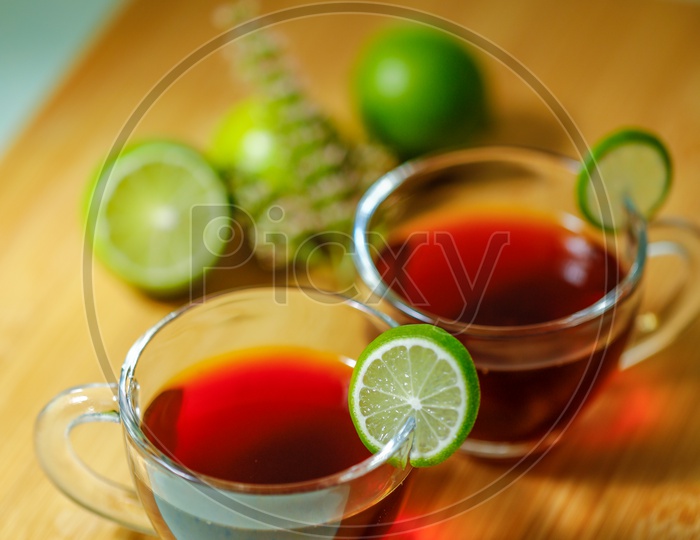 Black Tea In a Glass Cup With Lemons  on an Wooden Table Background