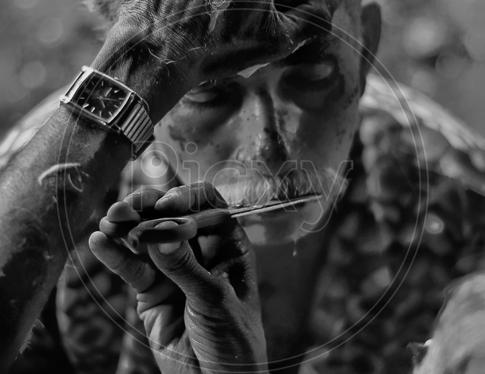 Barber Trimming Mustache Of an Indian Man With Scissors