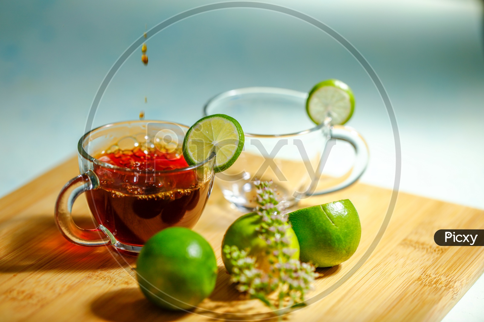 Black Tea In a Glass Cup With Lemons  on an Wooden Table Background