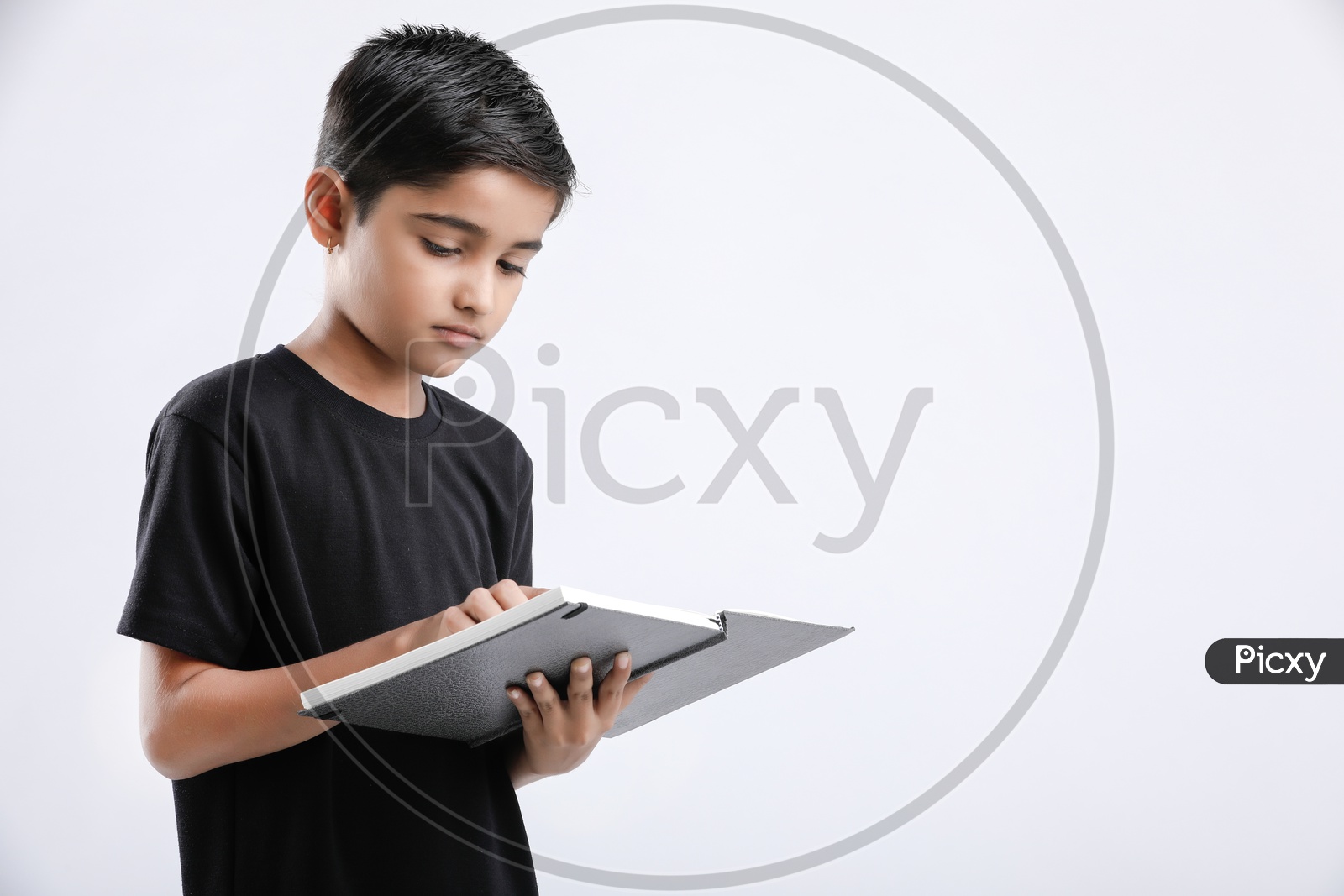 Indian or Asian Boy or Kid O r Child   Reading Book  over an Isolated White Background