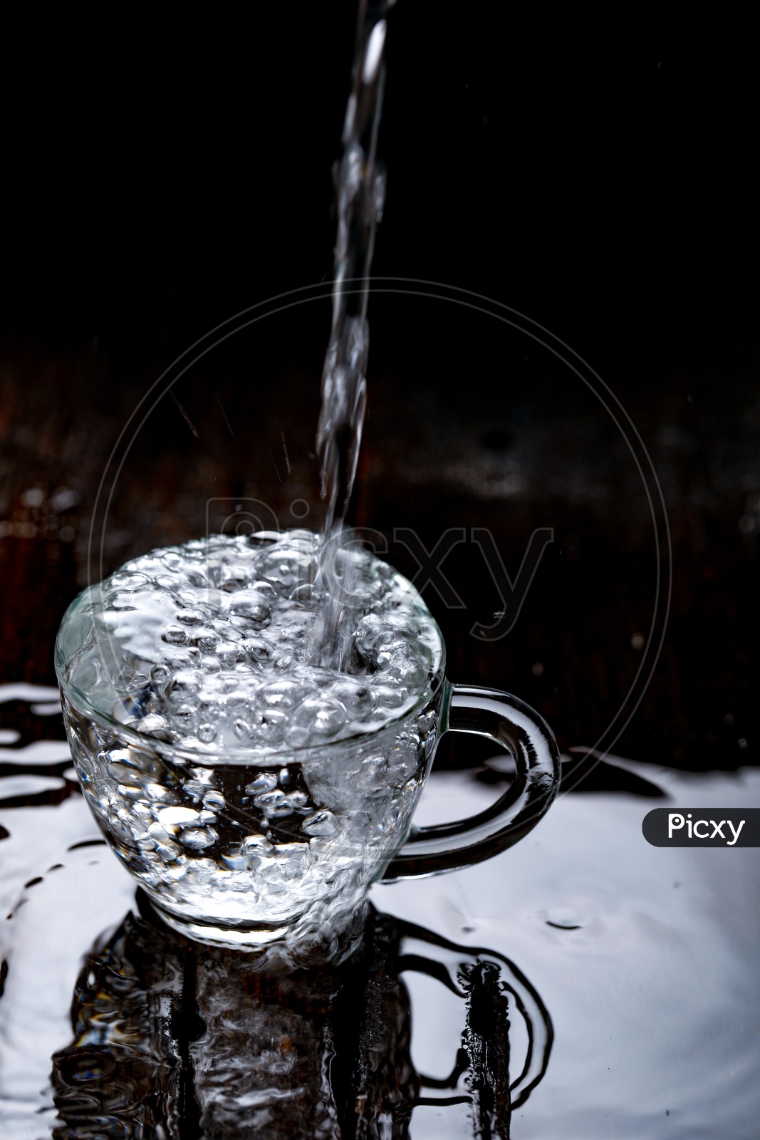 Empty Glass  Tea Cup Filling  With Water On an Wooden  Table Background