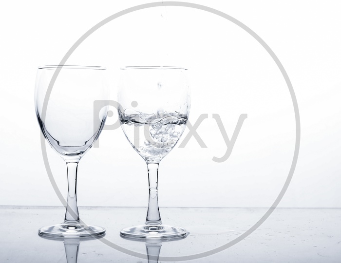 Empty Wine Glasses Filled With Water On an Isolated White Background