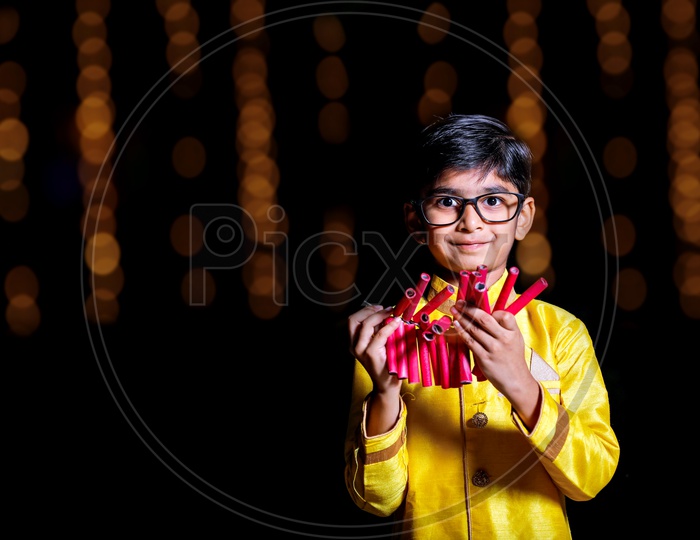 Indian Young Boy Or Kid In Traditional Wear Celebrating Diwali Festival