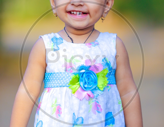 Cute Indian Girl Child or Baby Girl Playing With Multiple Expressions in Outdoor