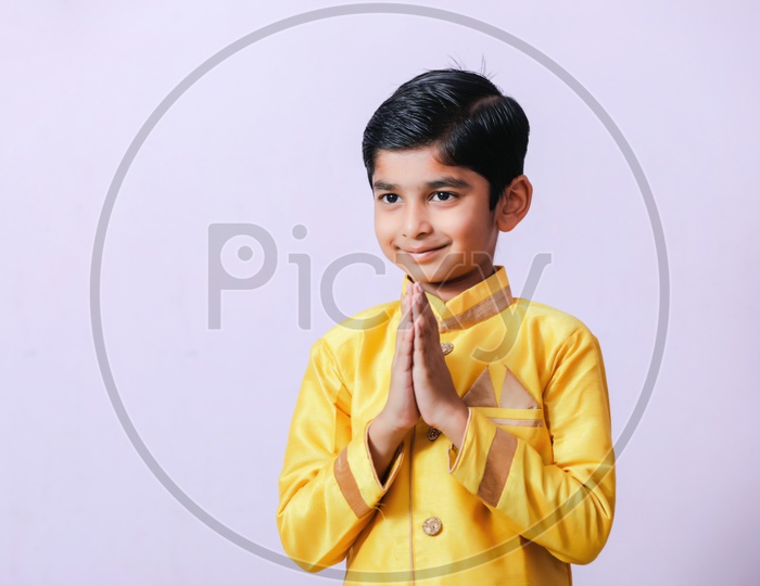 Young Boy Kid Child  in Traditional Wear With Namaste Gesture or Welcoming gesture on Festival Day