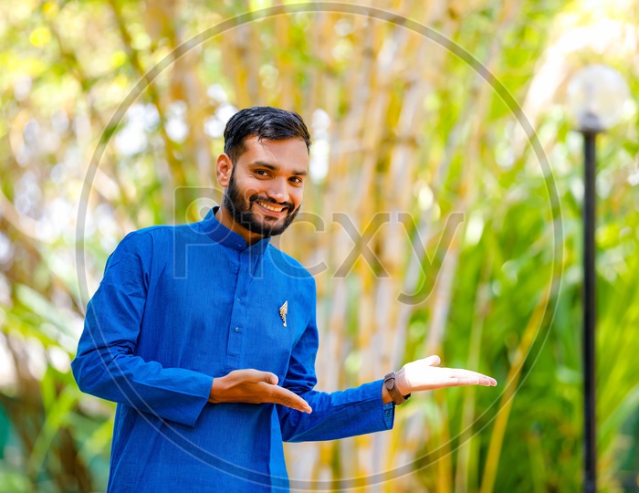 Indian Man Wearing Traditional Wear and Showing  Space