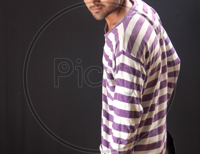 Indian Model Or Young Man Or Student Posing Over an Isolated Black Background