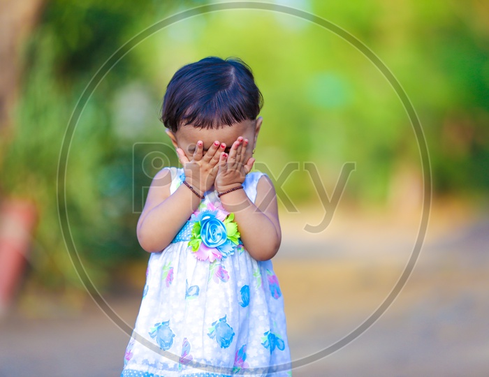 Cute Indian Girl Child or Baby Girl Playing With Multiple Expressions in Outdoor