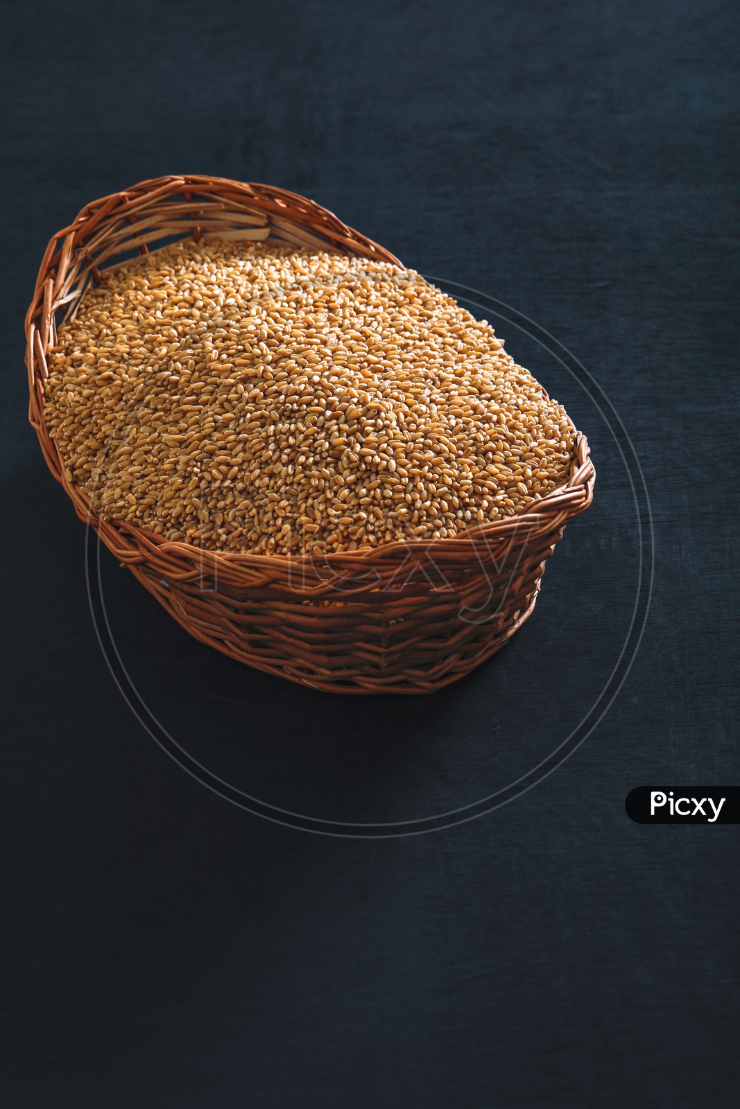 Wheat Grains In an Wooden Weaved Basket On an Isolated Background
