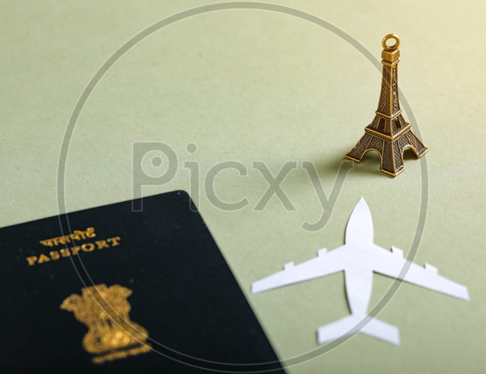 Travel Concept   Indian Passport , Paper Flight  and Eiffel Tower On an isolated Background