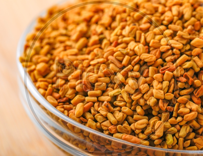 Fenugreek Seeds In a Glass Bowl on an Wooden Table