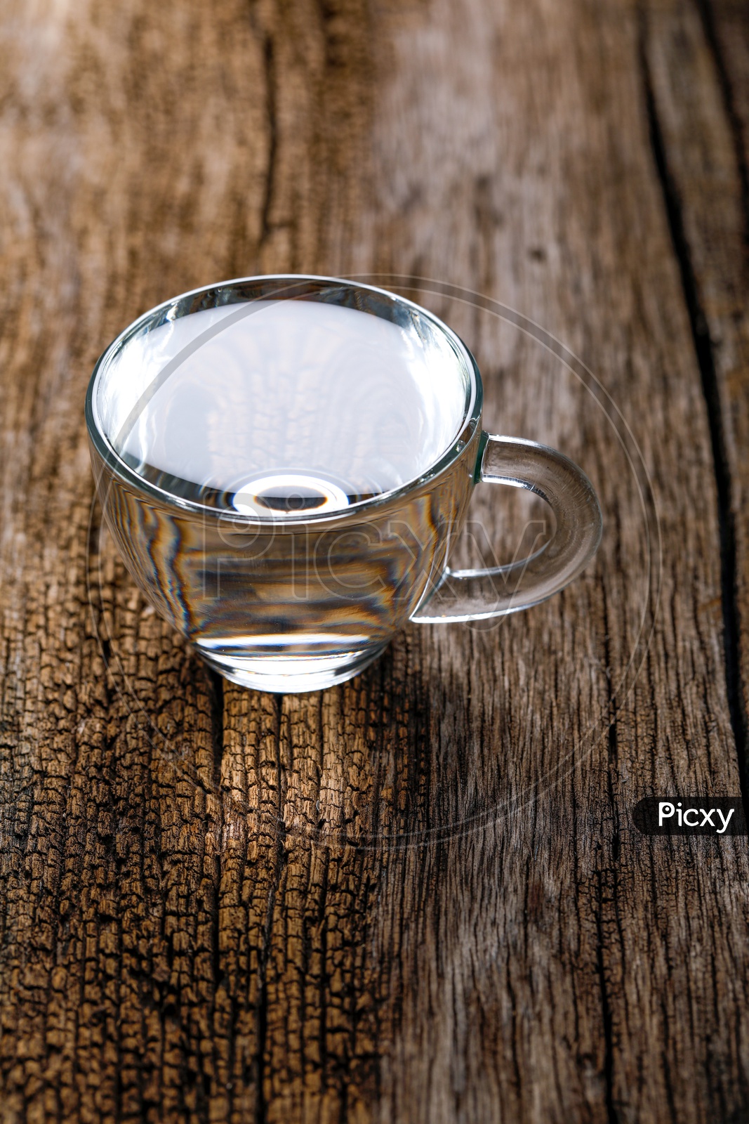 Water Filled In an Glass Tea Cup On an Wooden Table