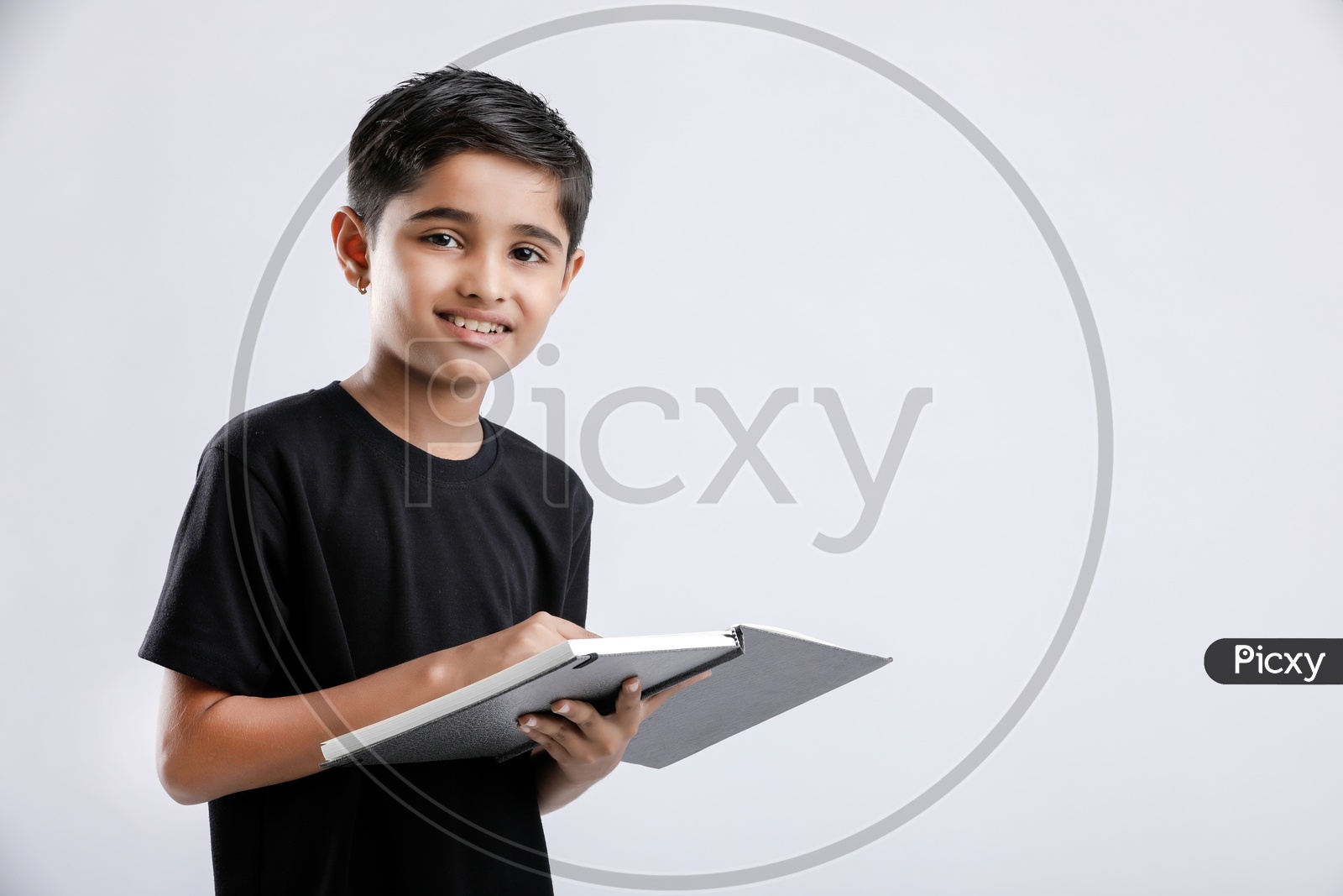 Indian or Asian Boy or Kid O r Child   Reading Book  over an Isolated White Background