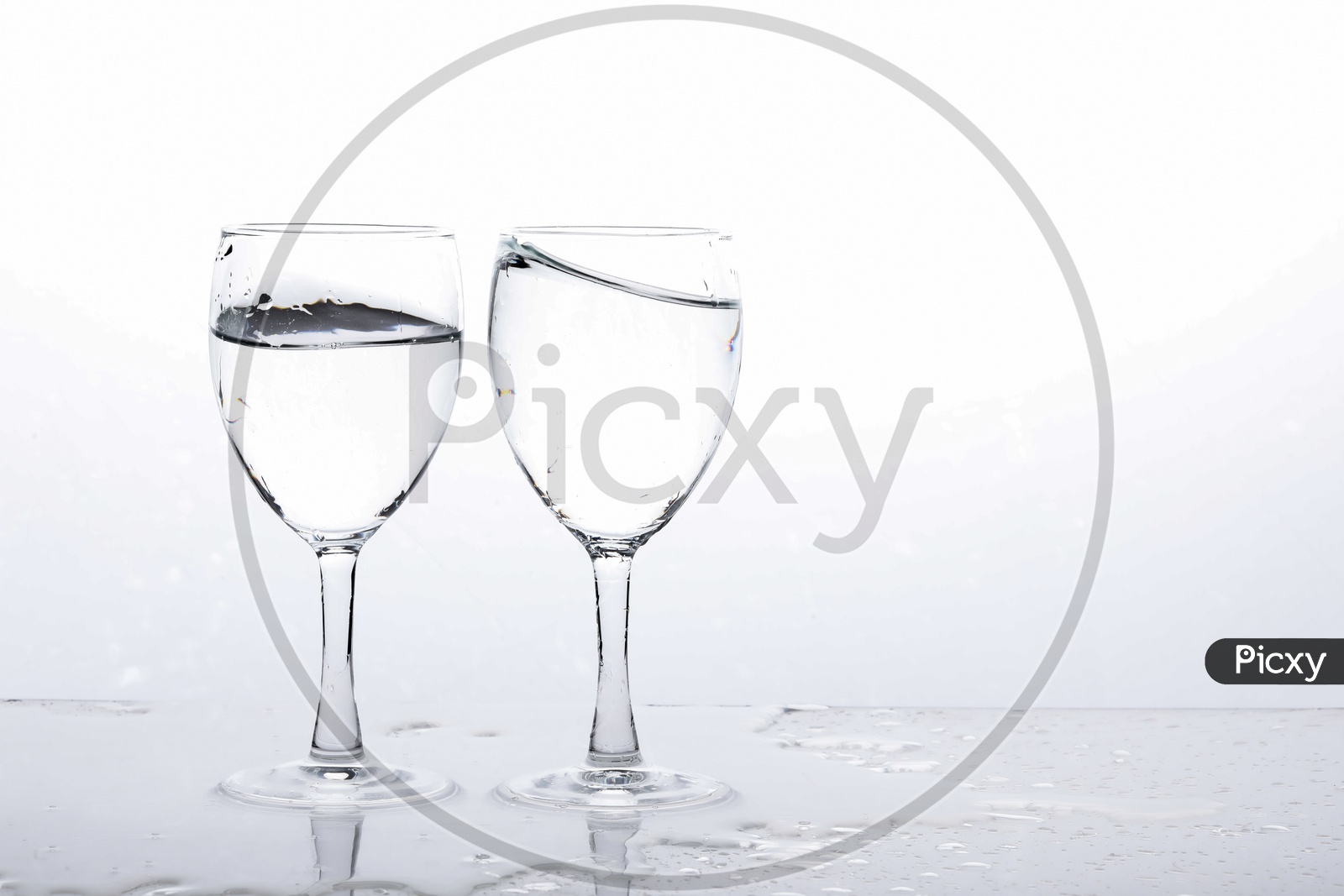 Empty Wine Glasses Filled With Water On an Isolated White Background