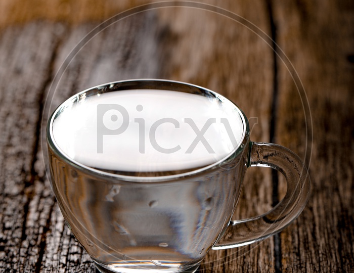 Water Filled In an Glass Tea Cup On an Wooden Table