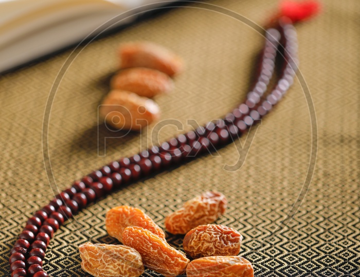 Dry Date Fruits  With Islamic Prayer beads on an Artistic Background   Backgrounds For Ramzan or Ramadan