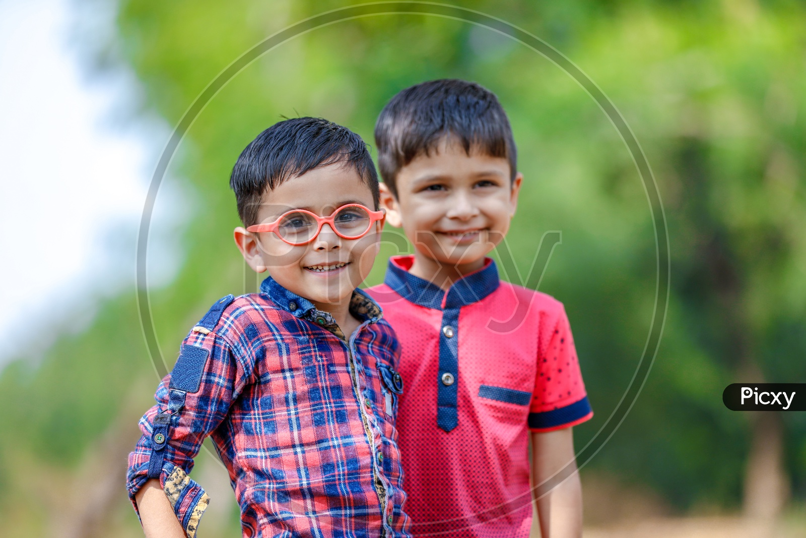 Two Cute Indian Kids Or Boys  or Siblings  or Friends Smiling On Outdoor Background