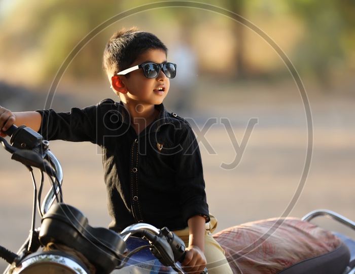 Young Indian Boy  kid Or Child on Bike  Posing on outdoor Background