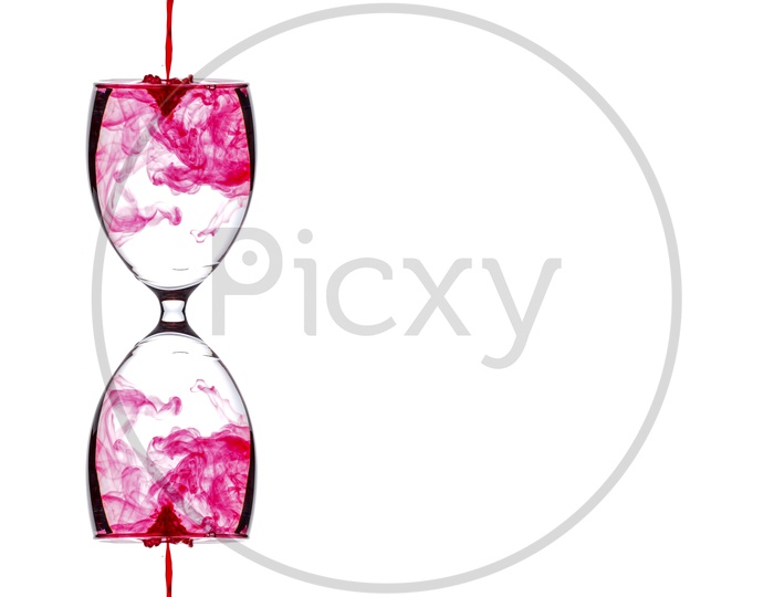 Colours Or Colouring Diffuse  inside Water  in a Wine Glass On an Isolated White Background
