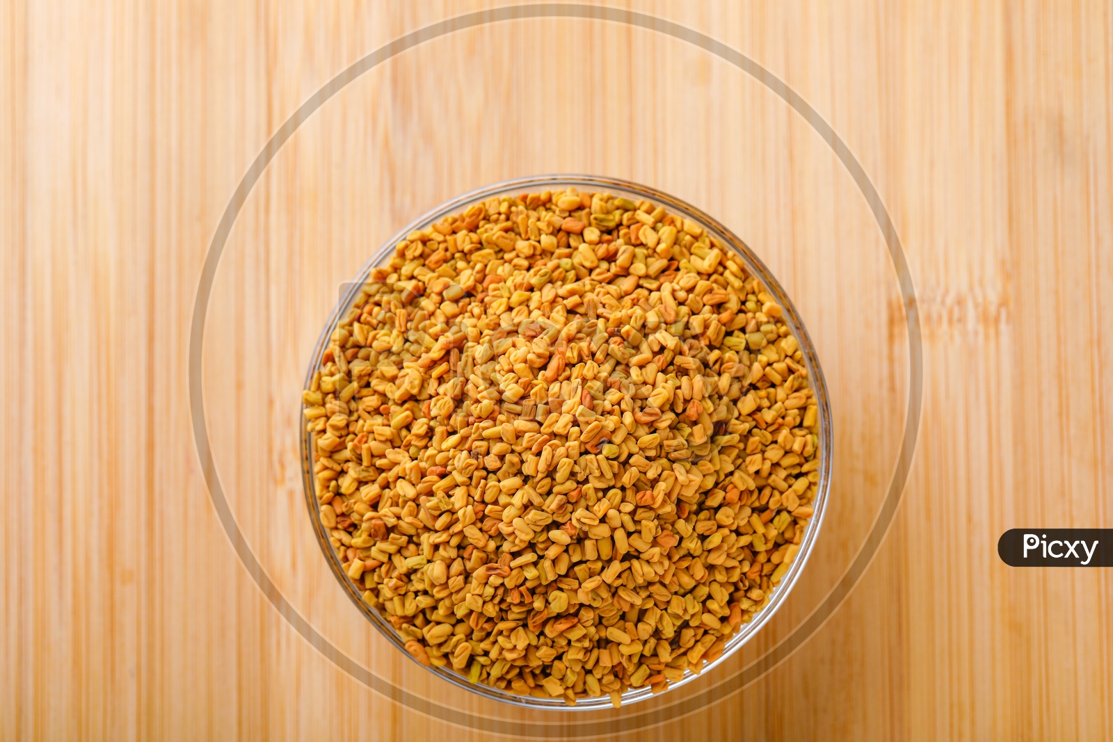 Fenugreek Seeds In a Glass Bowl on an Wooden Table