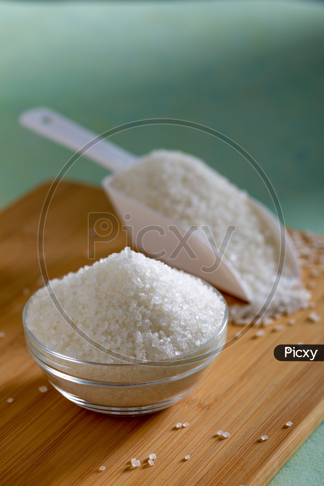 Sugar in a Glass Bowl  On an Wooden Background