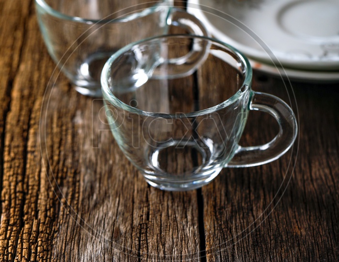 Empty Glass Tea Cups On an Wooden Table Background