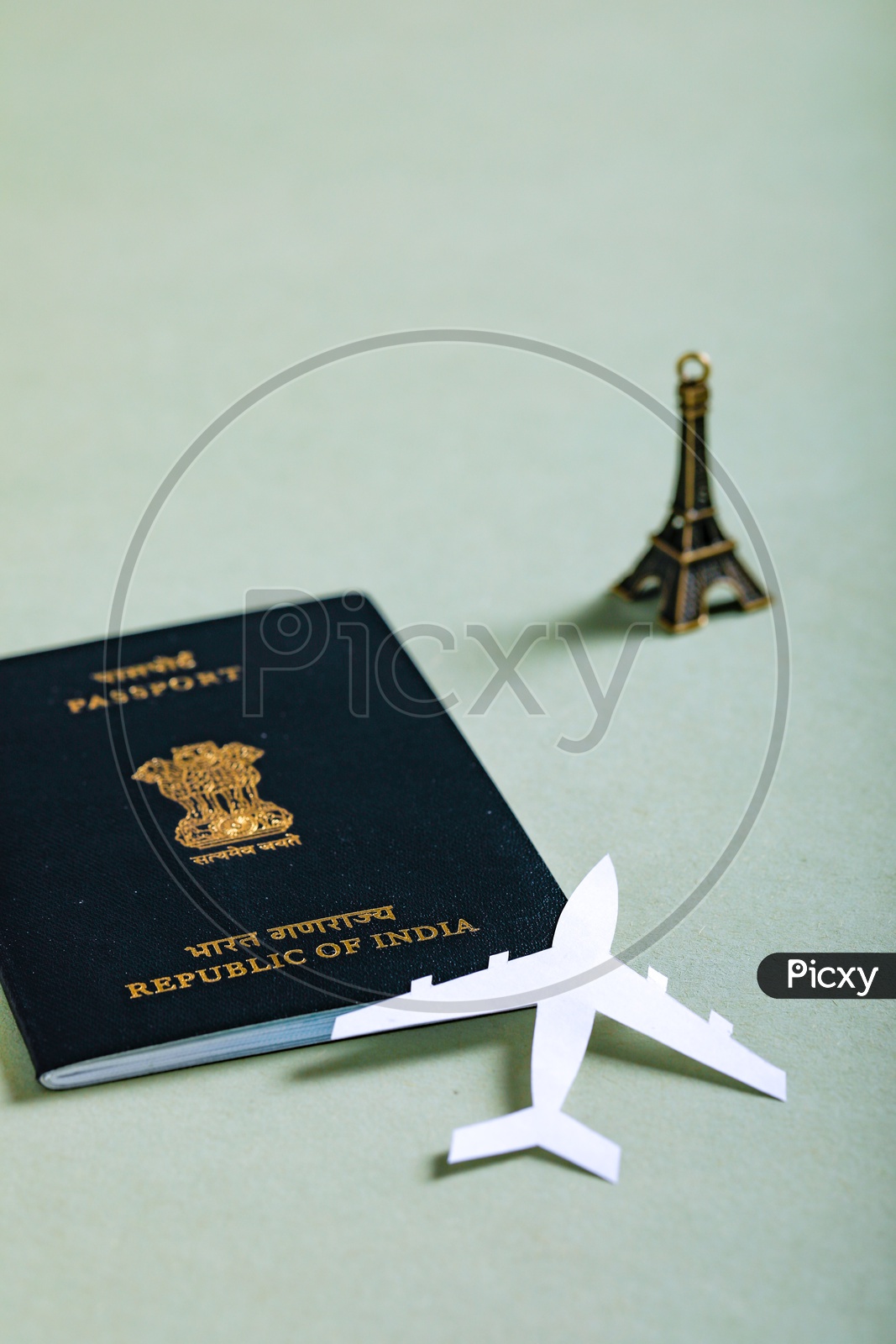 Travel Concept  Indian Passport And Paper Airplane Eiffel Tower Miniature on an Isolated White Background