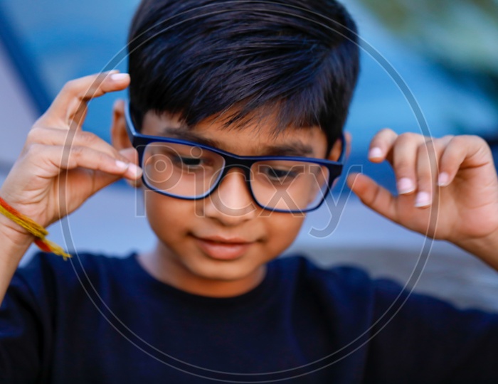 Indian Young Kid or Child Wearing Spectacles And Posing