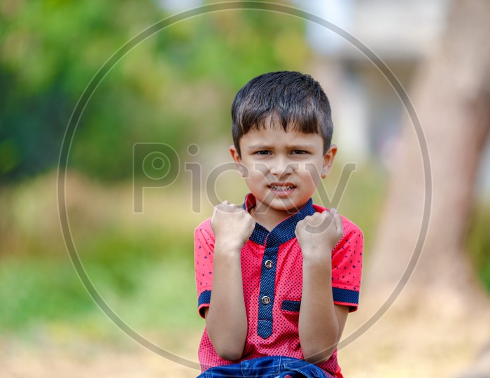 Indian Boy With Multiple Expressions On Outdoor Background
