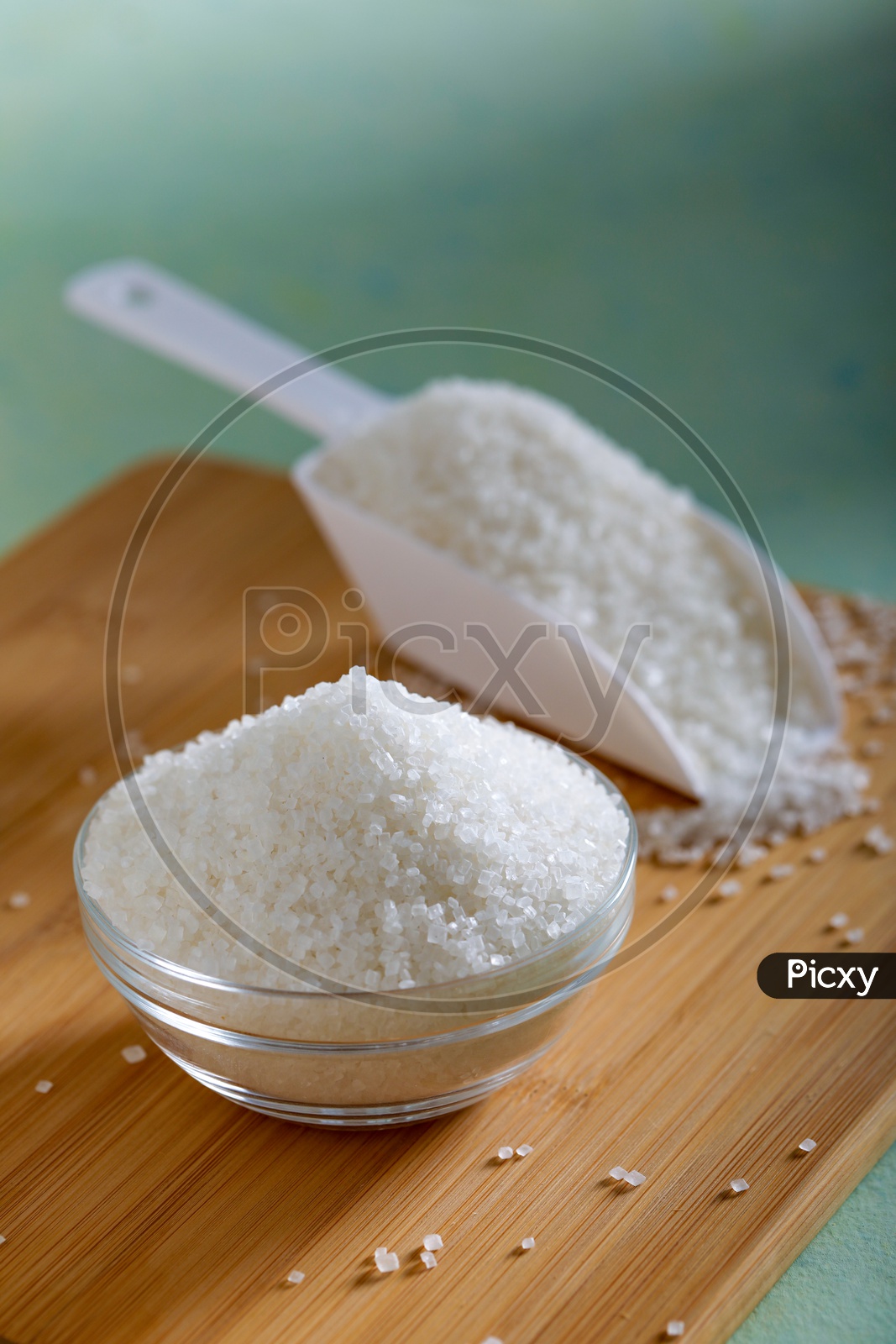 Sugar in a Glass Bowl  On an Wooden Background